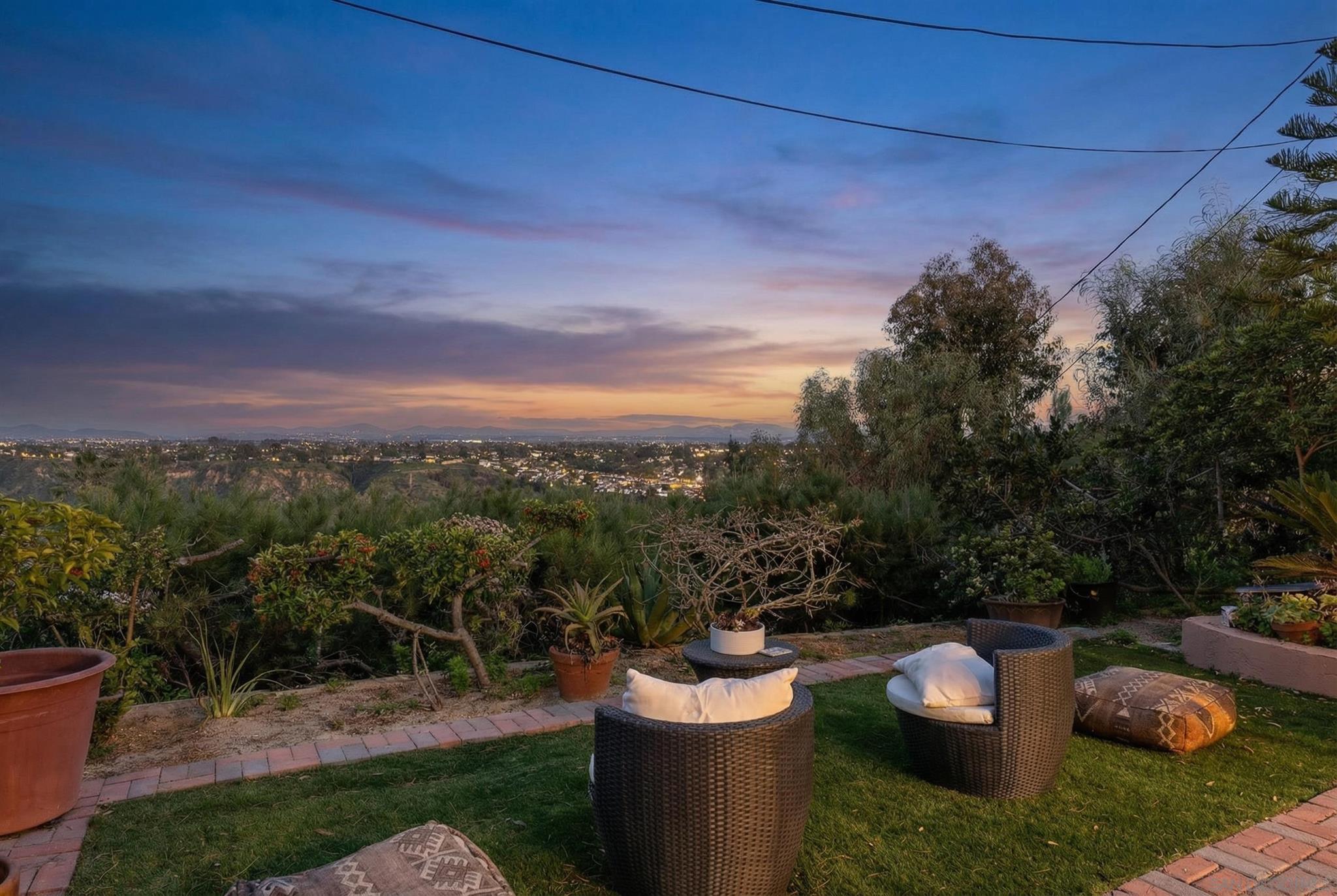 Backyard patio at twilight with canyon and city views