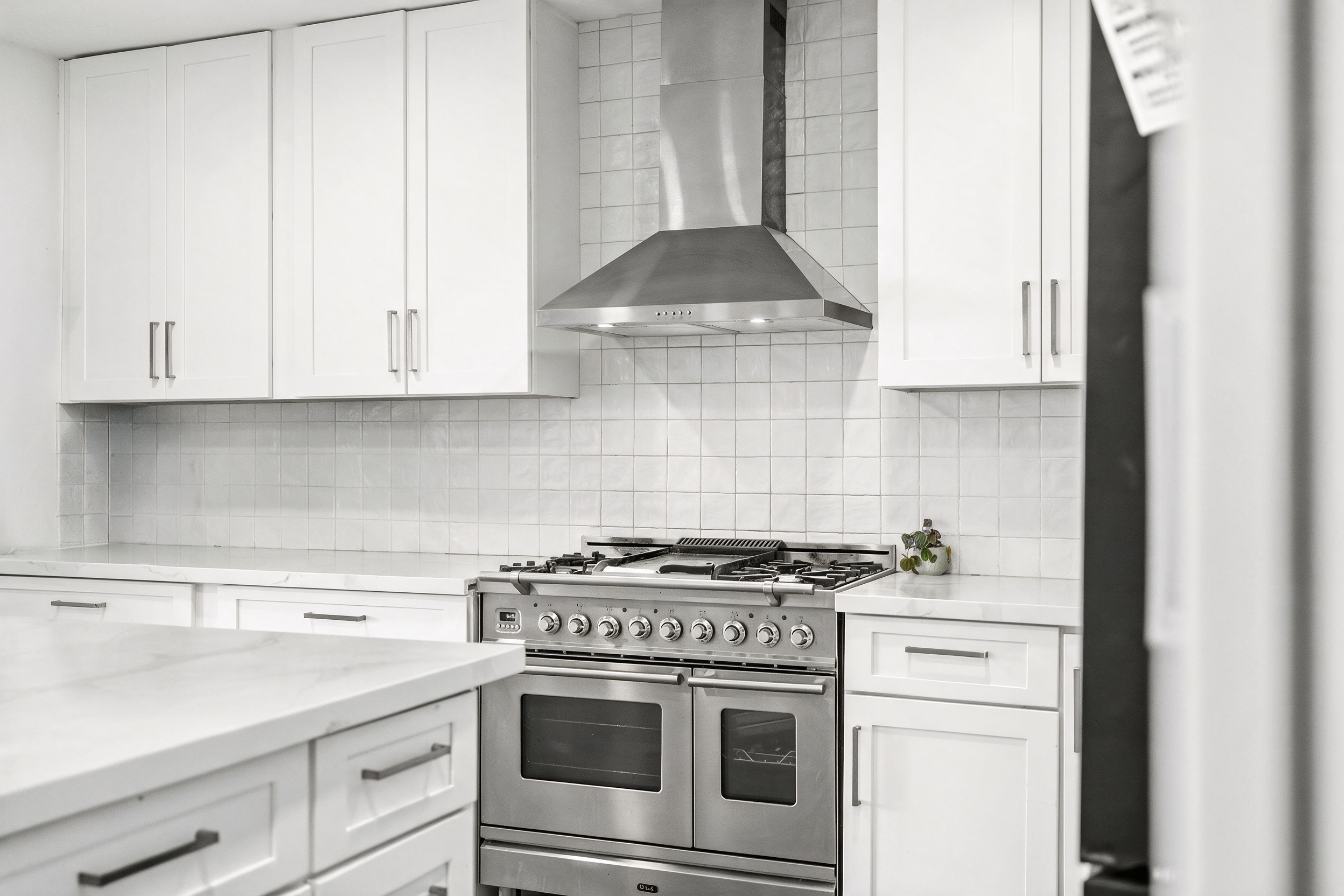 Kitchen with handcrafted ILVE range and stainless hood