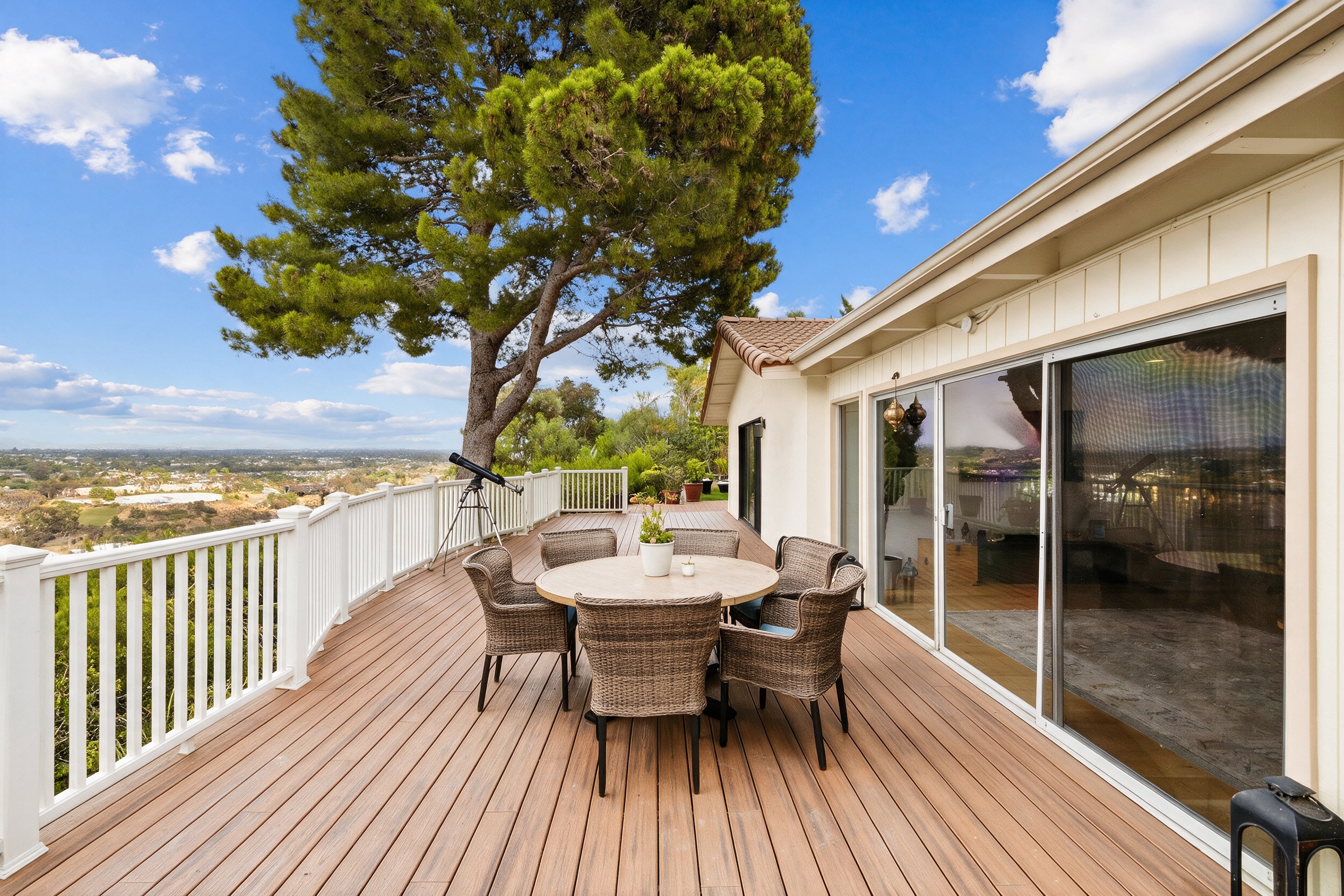Full-width view deck with dining set overlooking the canyon